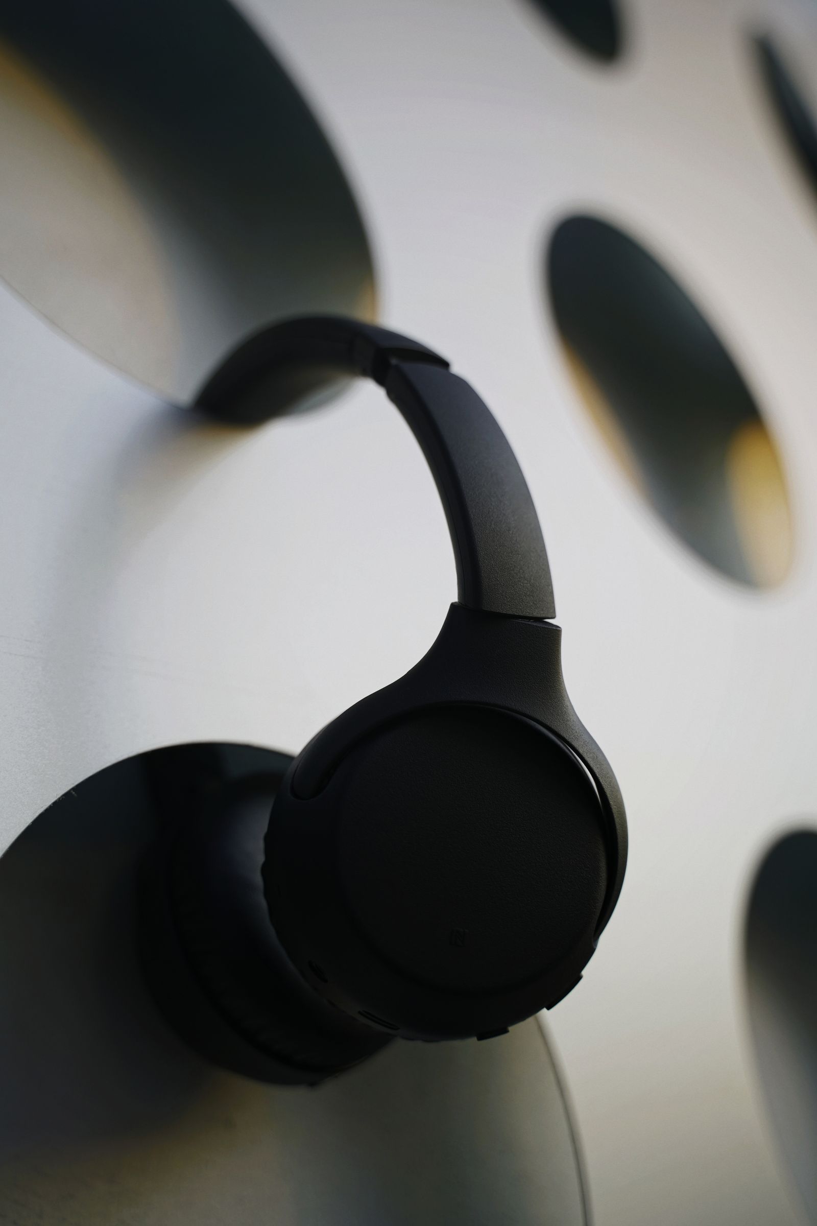 Close view of a black headphone earcup and headband