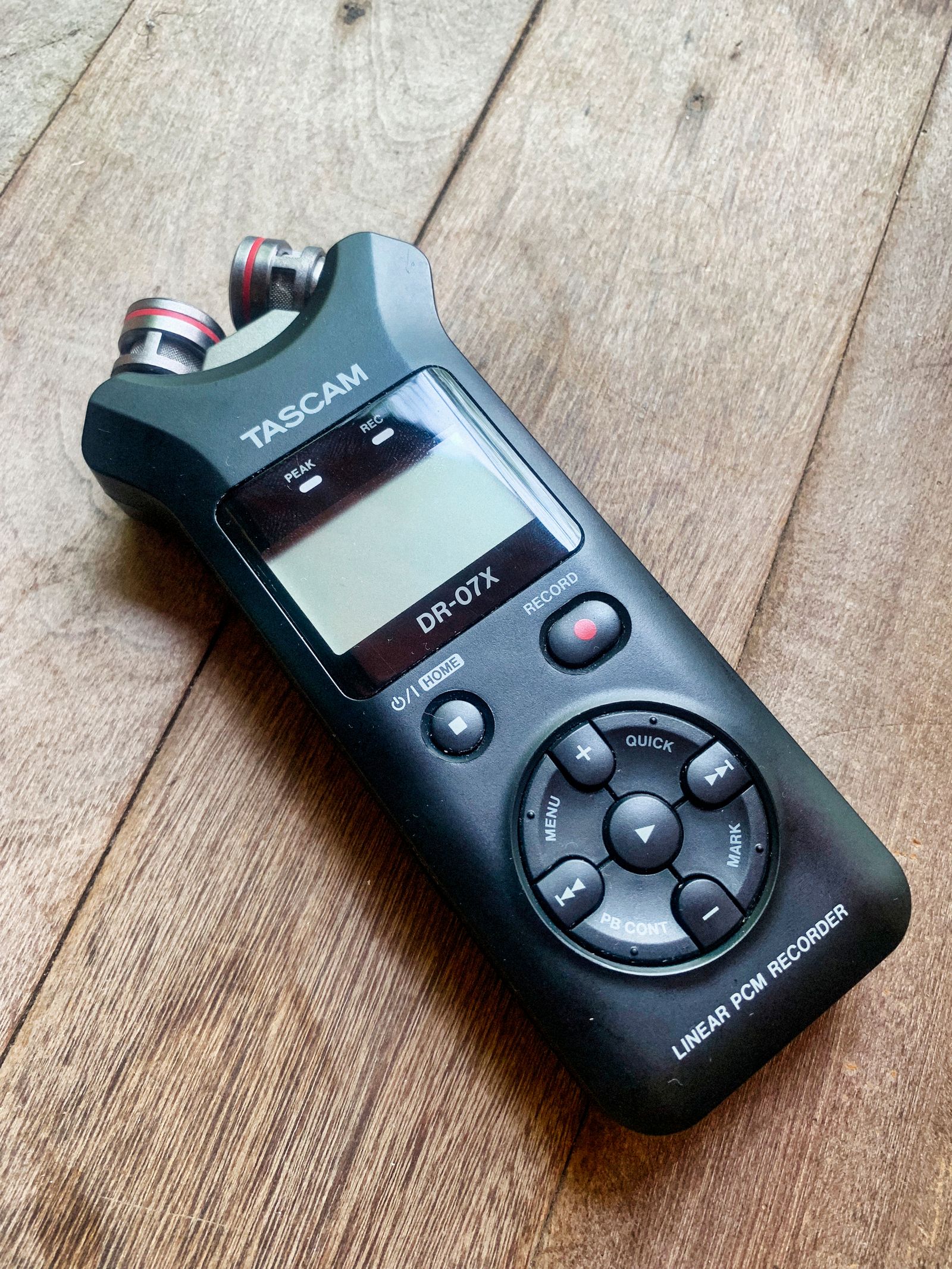 Portable stereo recorder on a wooden surface