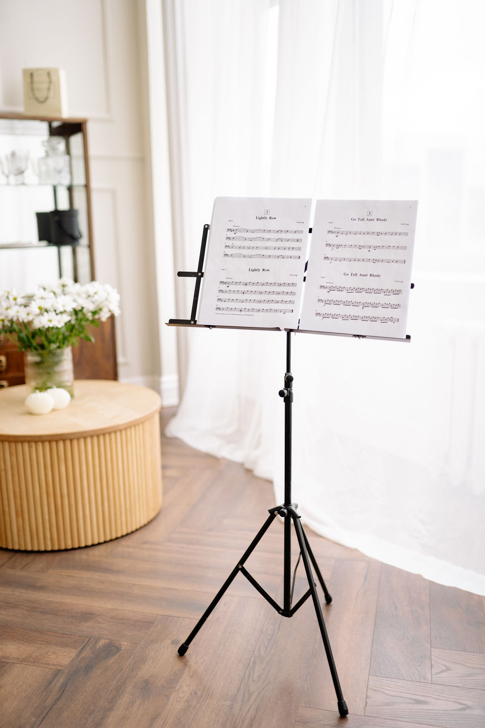 Tripod music stand holding open sheet music