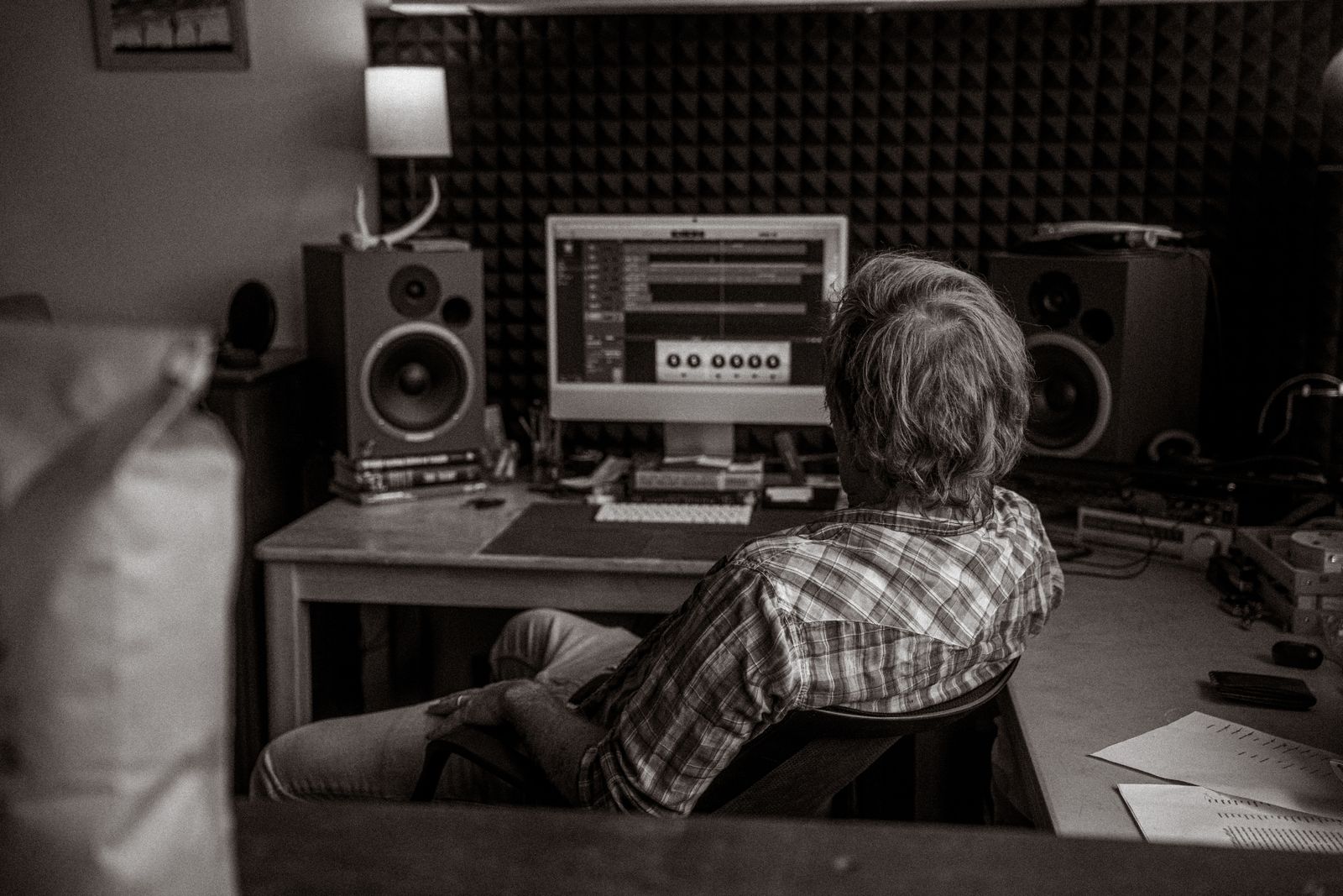 Person editing audio at a studio computer