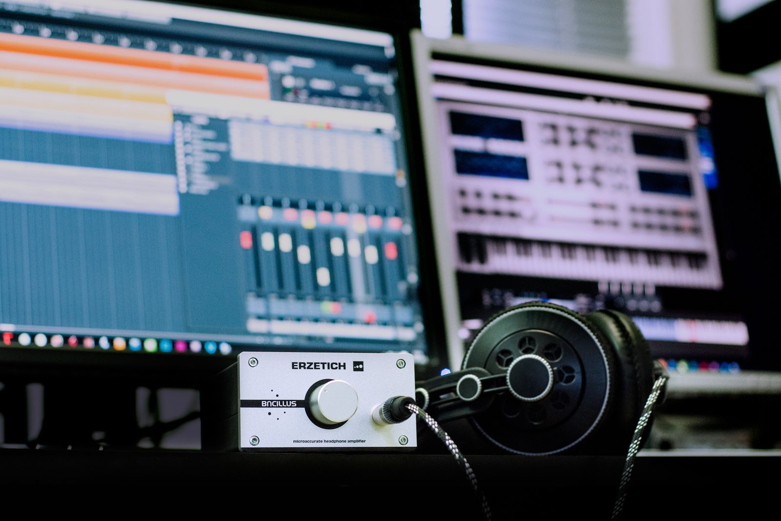 Headphones resting beside desktop audio equipment