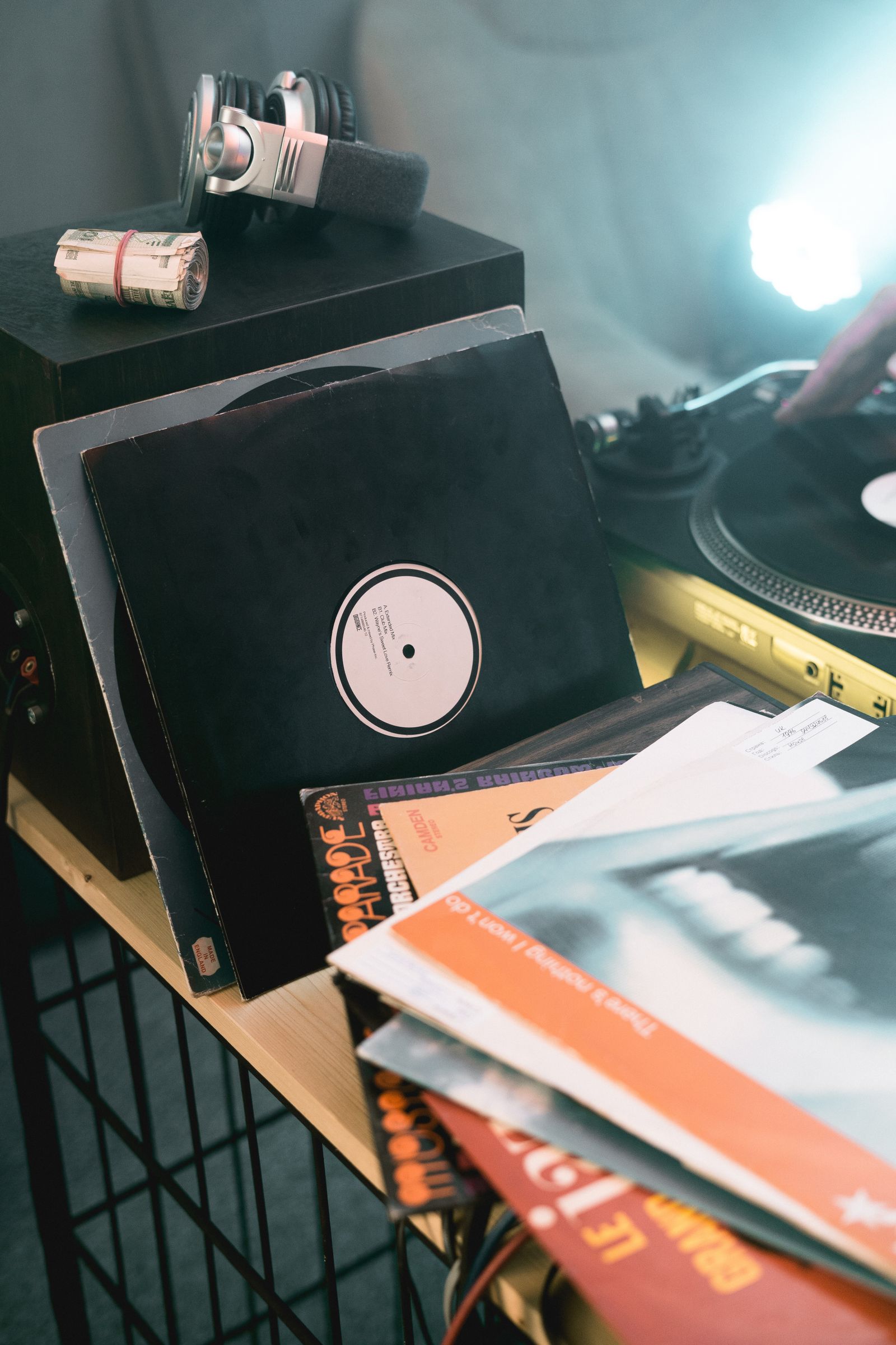 Vinyl records and sleeves beside a turntable